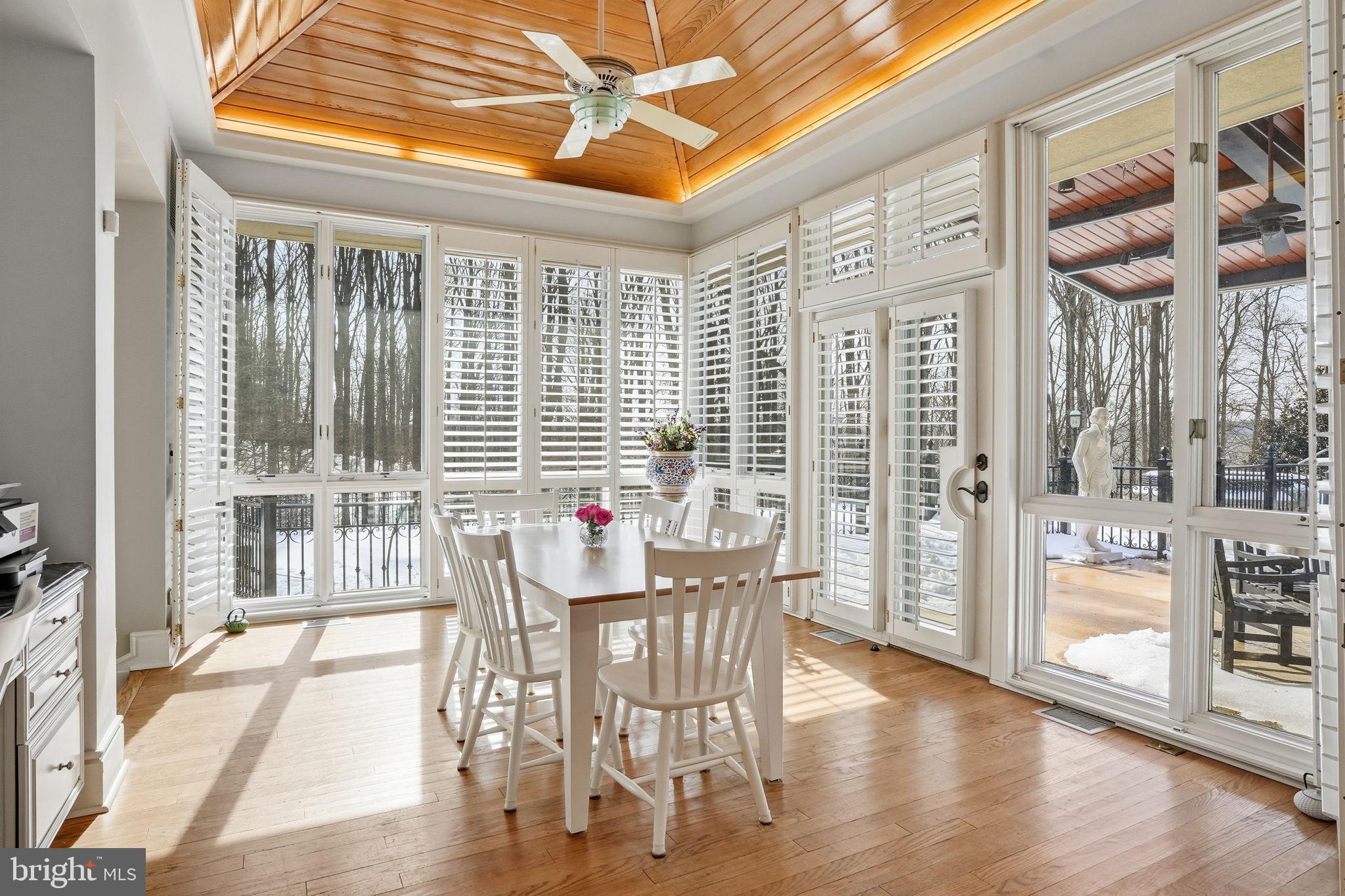 11940 River Road Potomac, MD 20854 - Photo 18 of 75 a dining room with wooden floor and large windows