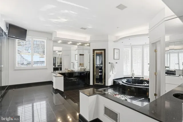 a kitchen with granite countertop white cabinets and stainless steel appliances
