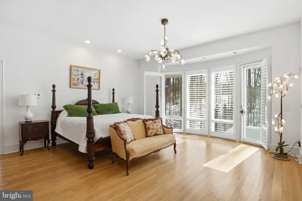 a living room with furniture fireplace and large windows