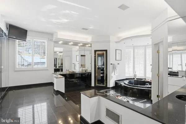 a room with pool table and windows