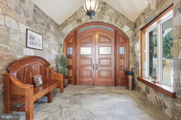 a view of entryway and hallway with a front door