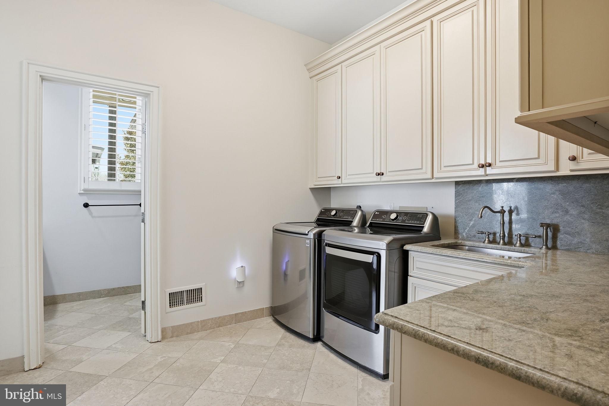 11940 River Road Potomac, MD 20854 - Photo 32 of 75 a kitchen with granite countertop white cabinets and stainless steel appliances