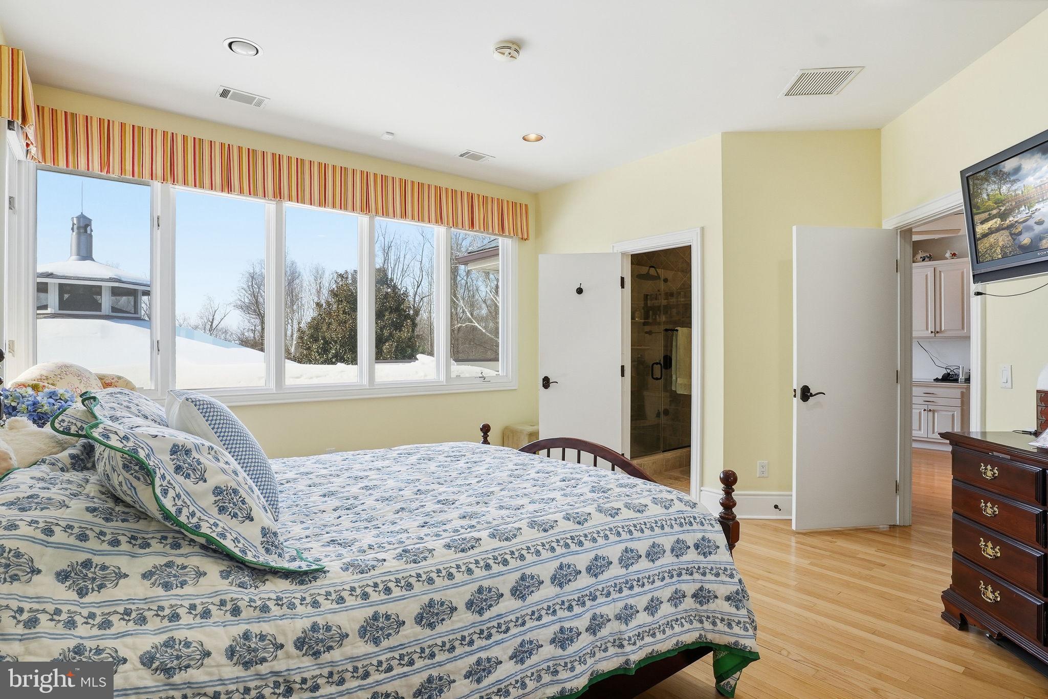 11940 River Road Potomac, MD 20854 - Photo 39 of 75 a bedroom with a bed and a large window
