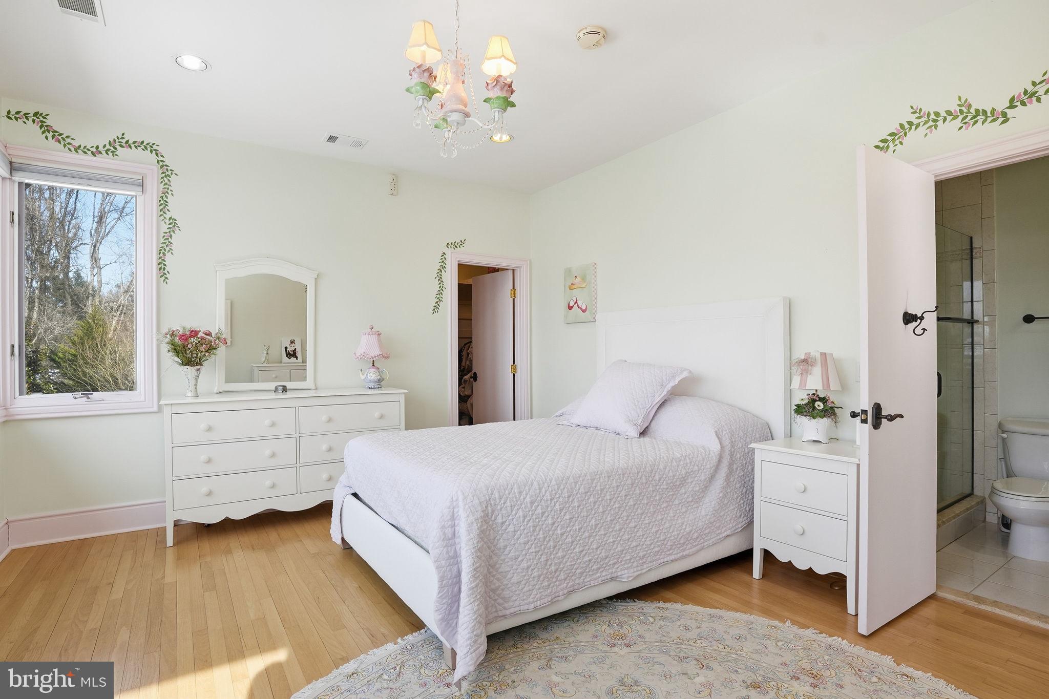 11940 River Road Potomac, MD 20854 - Photo 41 of 75 a bedroom with a bed and a chandelier