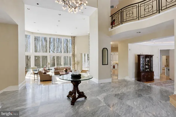 a living room with fireplace furniture and a large window