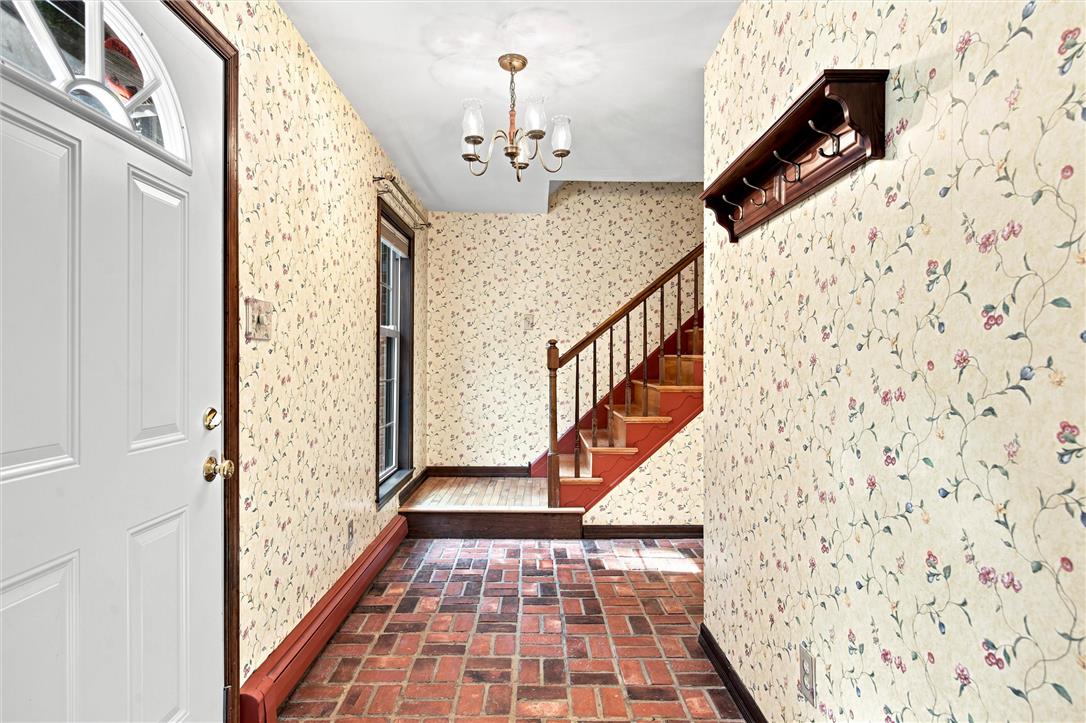 475 Crowthers Road Quakertown, PA 18951 - Photo 25 of 93 Enter into a charming foyer, featuring durable brick flooring and a classic wooden staircase.