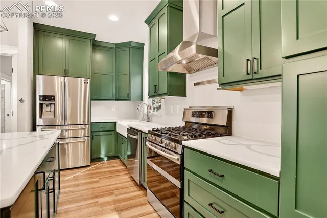 a kitchen with stainless steel appliances granite countertop a stove and a refrigerator