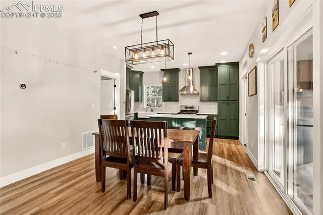 a view of a dining room with furniture window and wooden floor