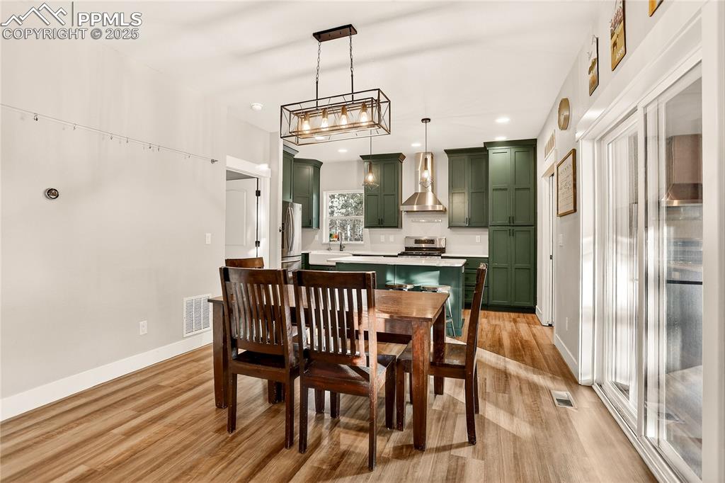 9920 Hodgen Road Colorado Springs, CO 80908 - Photo 15 of 49 a view of a dining room with furniture window and wooden floor
