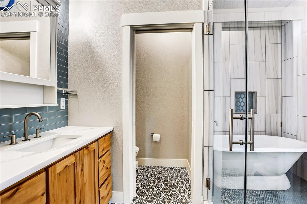 9920 Hodgen Road Colorado Springs, CO 80908 - Photo 20 of 49 a bathroom with a sink and a mirror