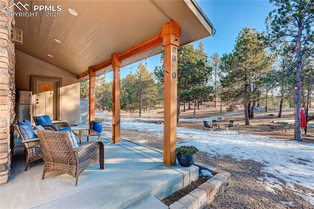 9920 Hodgen Road Colorado Springs, CO 80908 - Photo 4 of 49 a view of a patio with a table chairs and a backyard