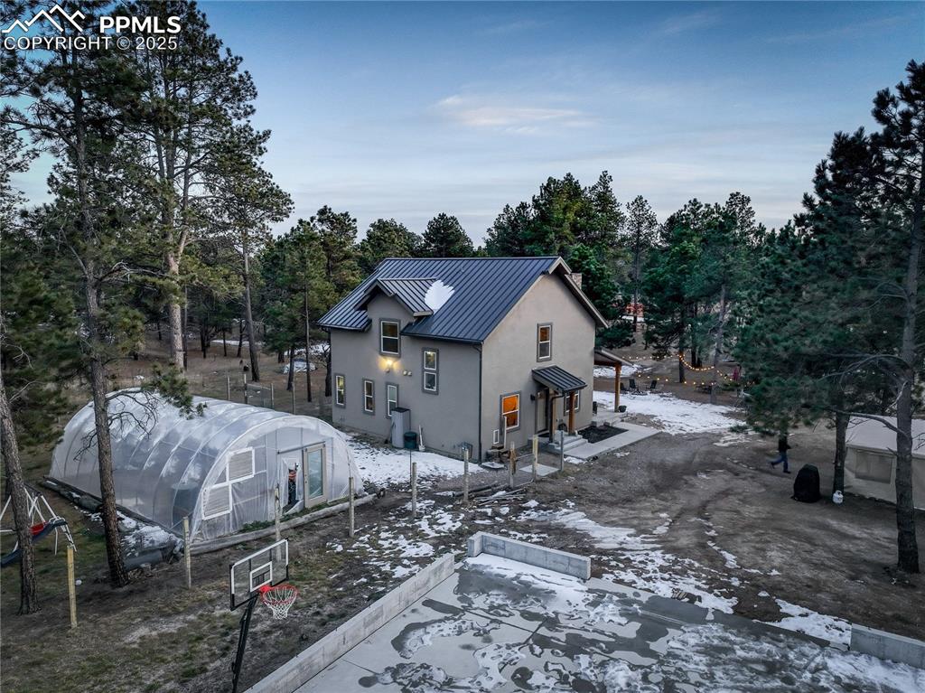 9920 Hodgen Road Colorado Springs, CO 80908 - Photo 41 of 49 a view of a house with a yard and large tree
