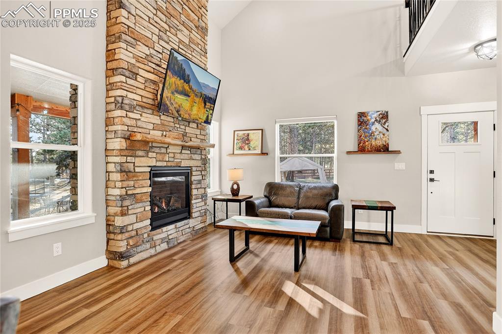 9920 Hodgen Road Colorado Springs, CO 80908 - Photo 7 of 49 a living room with furniture a fireplace and next to a window