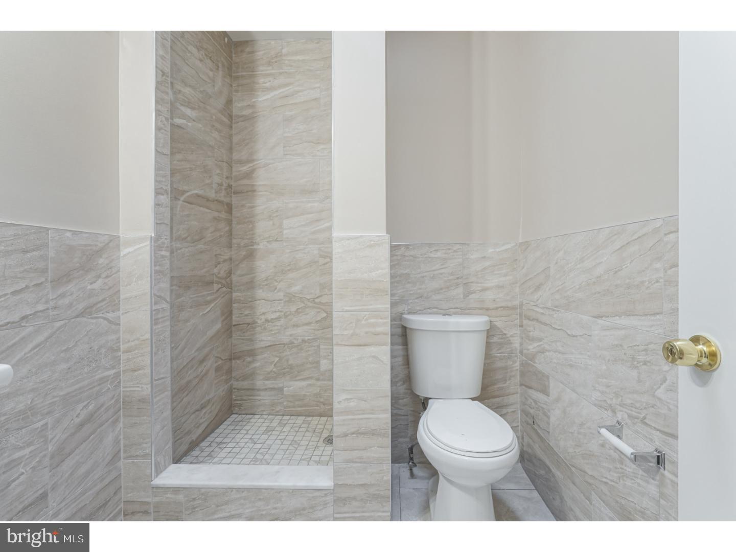 2118 South Lambert Street Philadelphia, PA 19145 - Photo 14 of 24 a bathroom with a toilet and a shower