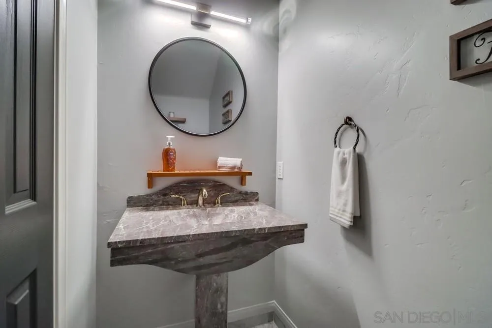15735 Lawson Valley Road Jamul, CA 91935 - Photo 13 of 37 a bathroom with a sink and a mirror