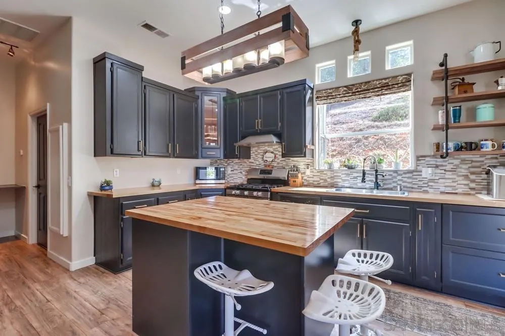 15735 Lawson Valley Road Jamul, CA 91935 - Photo 8 of 37 a dining table with chairs and window