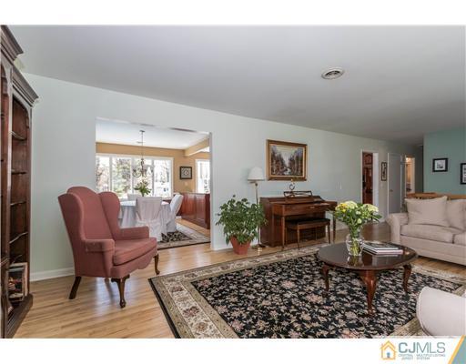 19 Moraine Road Edison, NJ 08820 - Photo 5 of 25 a living room with furniture a dining table and a potted plant