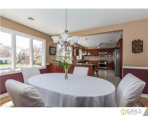 19 Moraine Road Edison, NJ 08820 - Photo 7 of 25 a living room with furniture a chandelier and a dining table