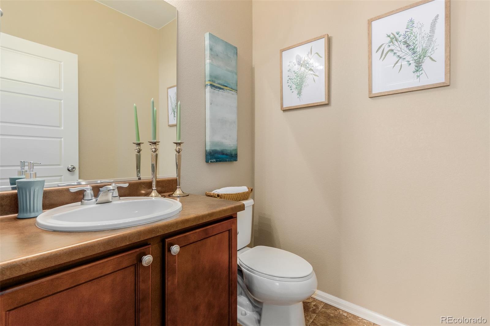 8546 Raspberry Drive Frederick, CO 80504 - Photo 16 of 44 a bathroom with a granite countertop sink mirror vanity and toilet