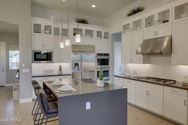 a kitchen with stainless steel appliances kitchen island granite countertop a stove a sink and a microwave