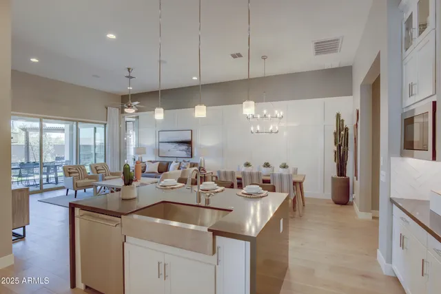 a kitchen with a sink stove and cabinets