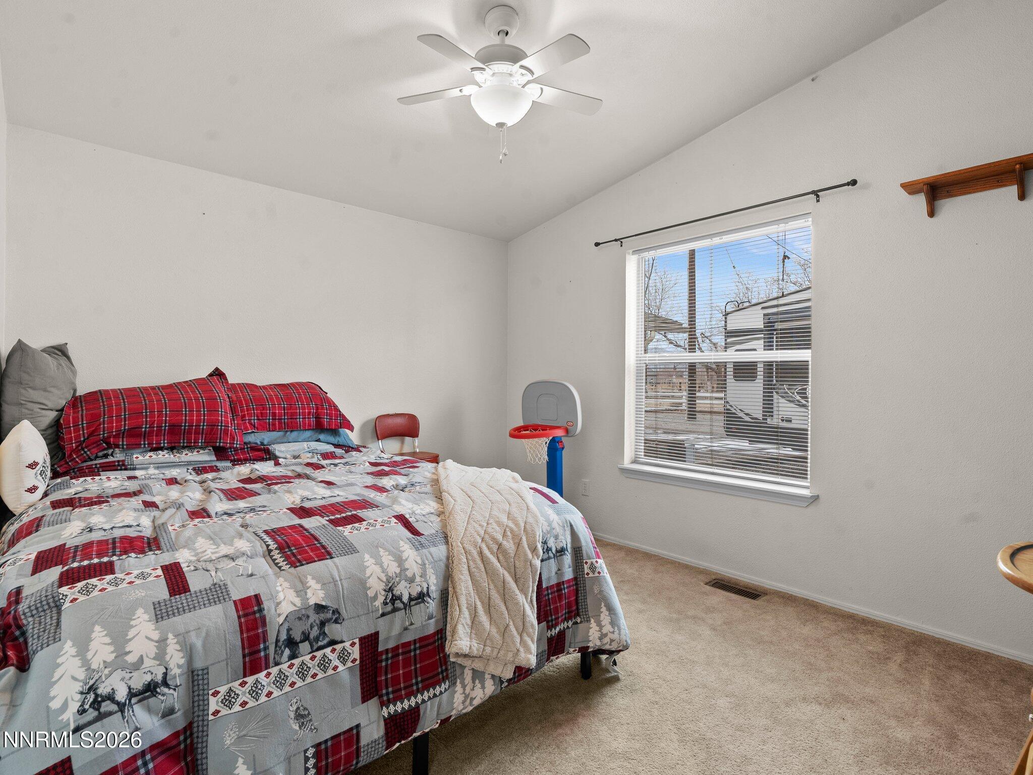 1125 Truckee Lane Fernley, NV 89408 - Photo 18 of 33 a bedroom with a bed and a chandelier