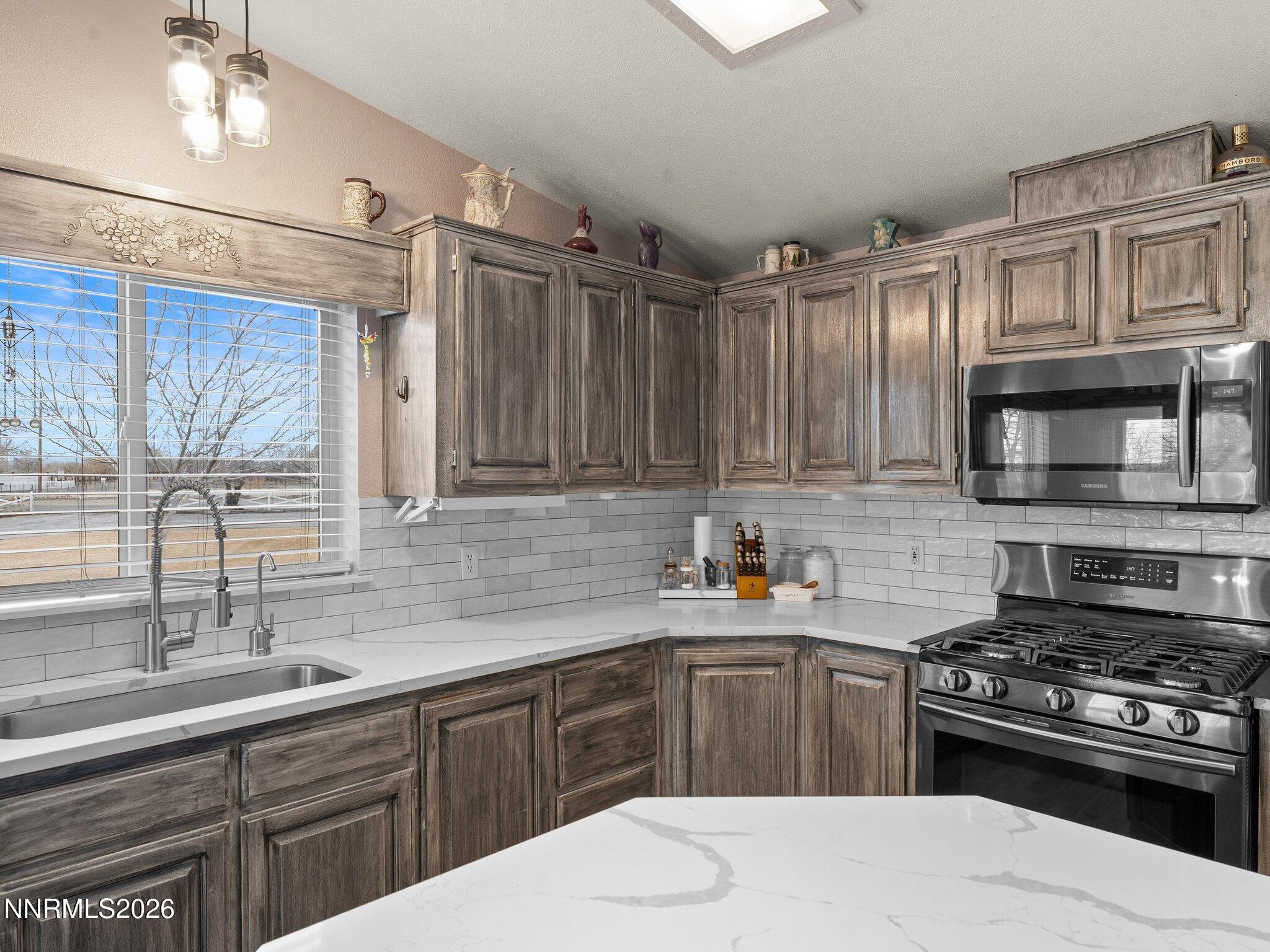 1125 Truckee Lane Fernley, NV 89408 - Photo 8 of 33 a kitchen with stainless steel appliances a sink stove and cabinets