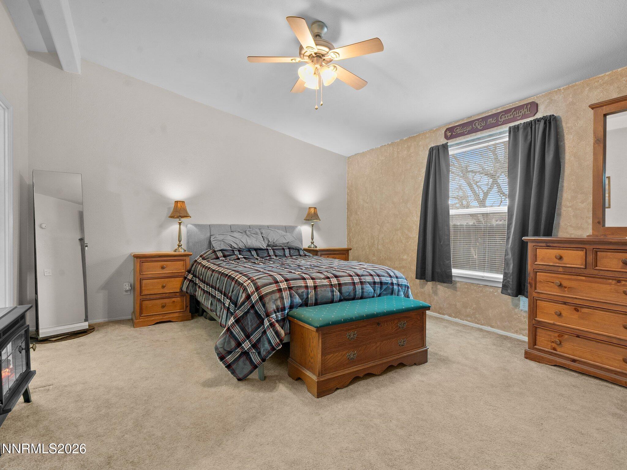 1125 Truckee Lane Fernley, NV 89408 - Photo 10 of 33 a bedroom with a bed and a chandelier