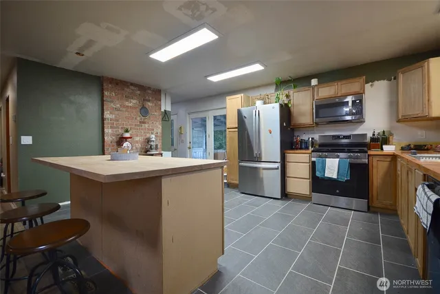 a spacious bedroom with a bed and wooden floor