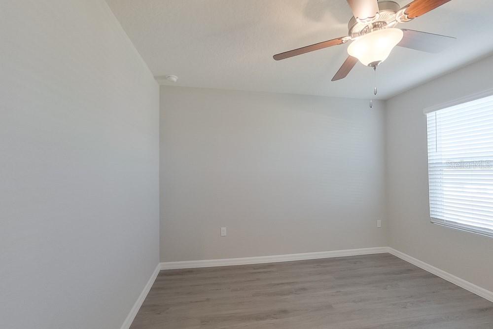 4397 Southwest 85th Lane Ocala, FL 34476 - Photo 12 of 23 an empty room with a window and a fan