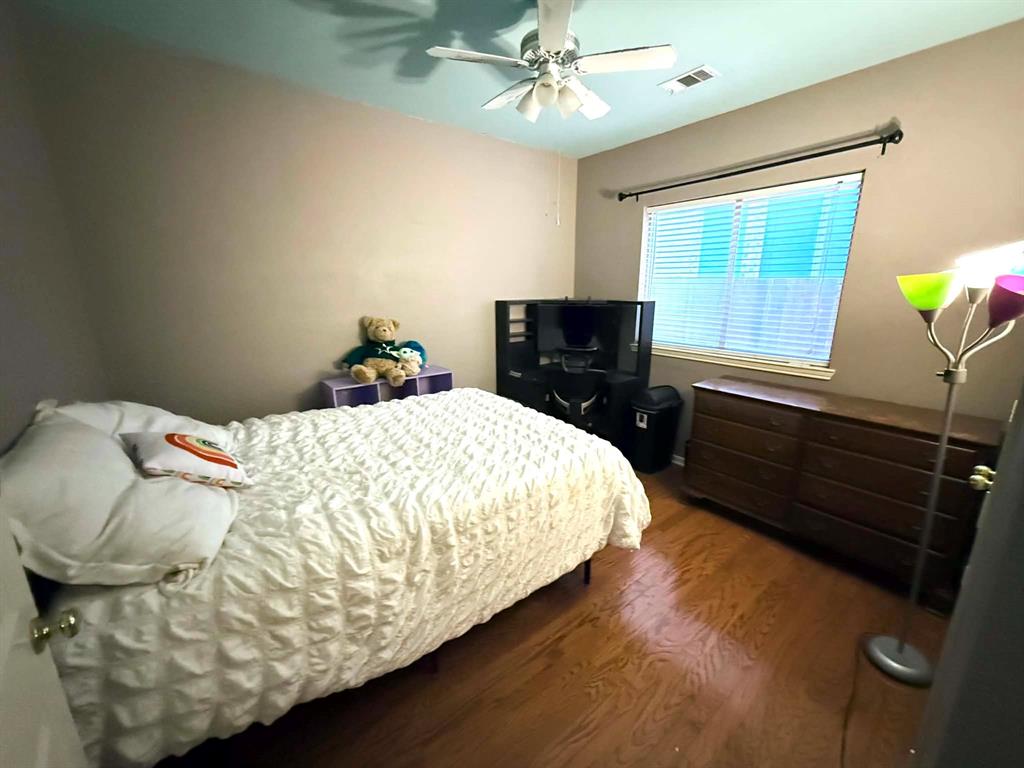 9117 Ripley Street Fort Worth, TX 76244 - Photo 27 of 31 Room featuring wood-finish flooring, a window with horizontal blinds, and a ceiling fan with integrated lighting