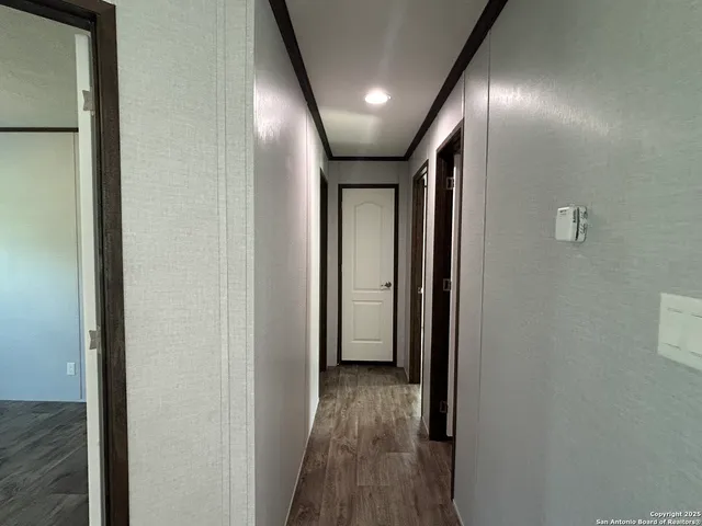 a view of hallway with stairs and wooden floor