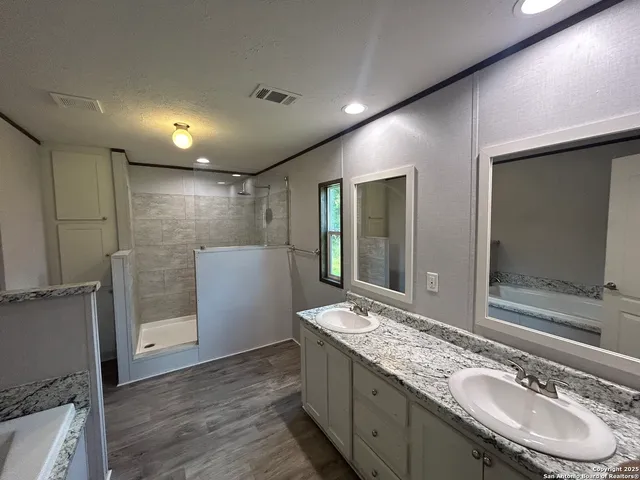 a bathroom with a sink double vanity and a mirror