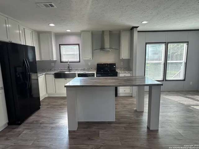 a kitchen with counter top space cabinets and appliances