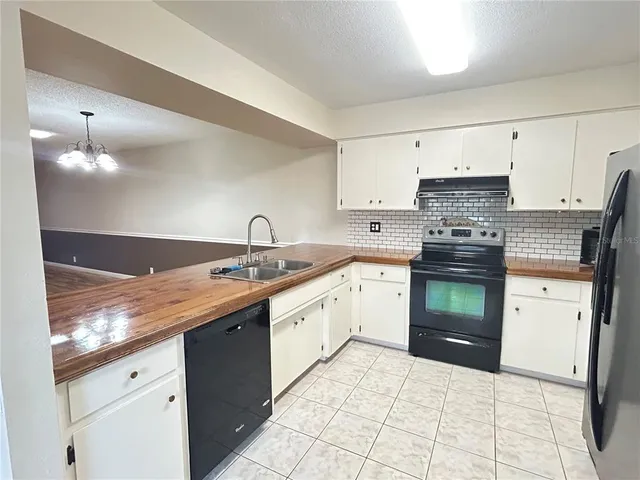 a kitchen with granite countertop a sink and cabinets