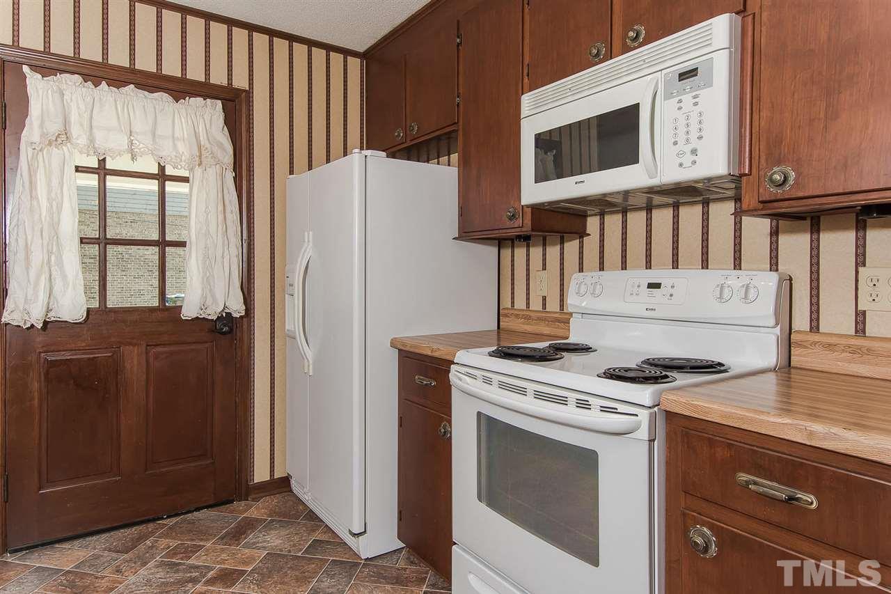 4213 Pin Oak Road Raleigh, NC 27604 - Photo 8 of 25 a kitchen with stainless steel appliances granite countertop a stove a refrigerator and a cabinets