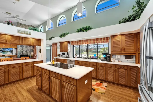 a kitchen with stainless steel appliances granite countertop a sink and a stove