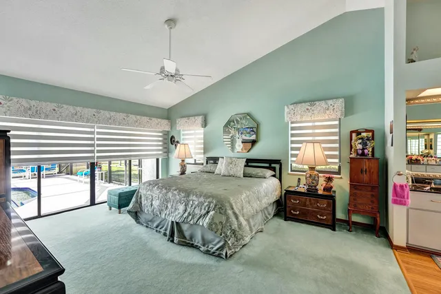 a spacious bedroom with a bed dresser and a window