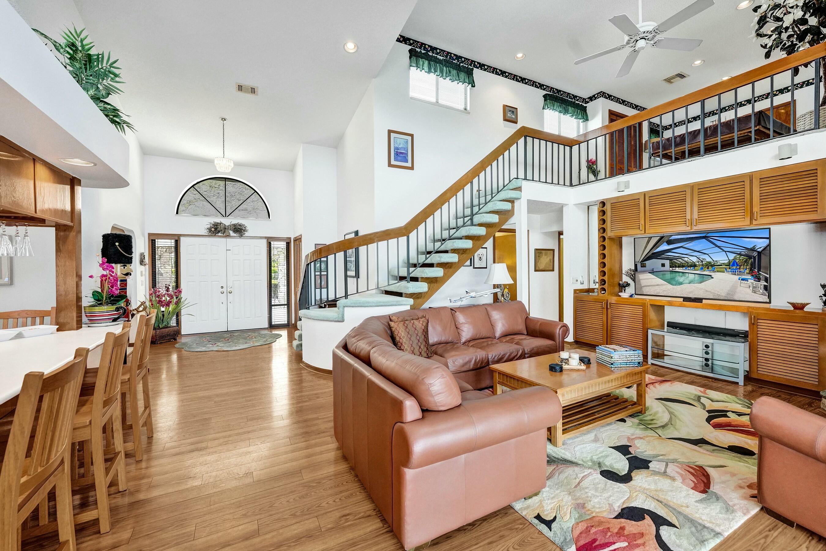3120 Southeast Downwinds Road Jupiter, FL 33478 - Photo 18 of 33 a living room with furniture or wooden floor and a large window