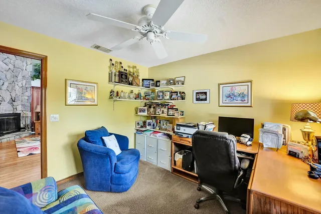 a view of a workspace with furniture and a workspace