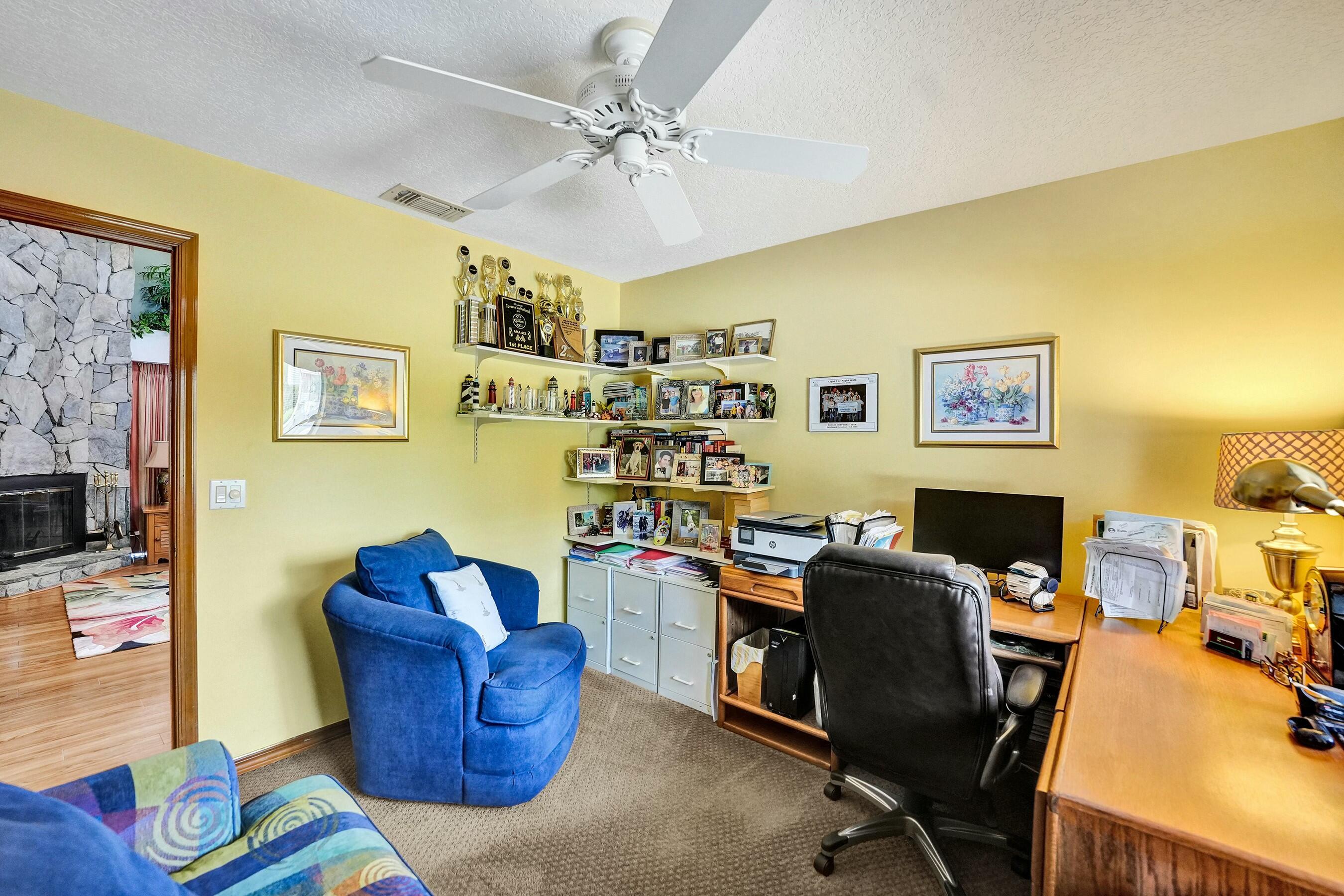 3120 Southeast Downwinds Road Jupiter, FL 33478 - Photo 19 of 33 a view of a workspace with furniture and a workspace