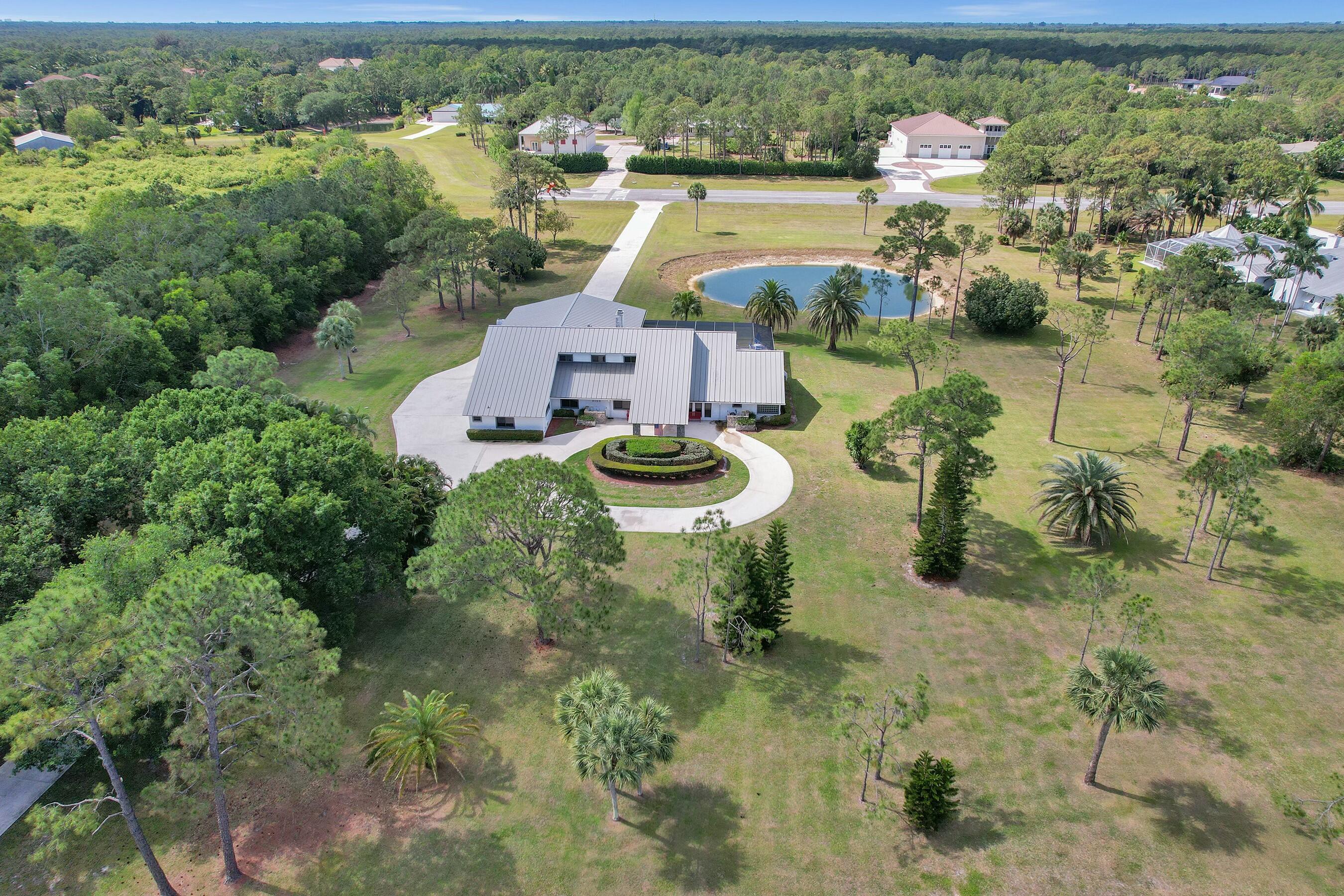 3120 Southeast Downwinds Road Jupiter, FL 33478 - Photo 2 of 33 an aerial view of a house with yard swimming pool and outdoor seating