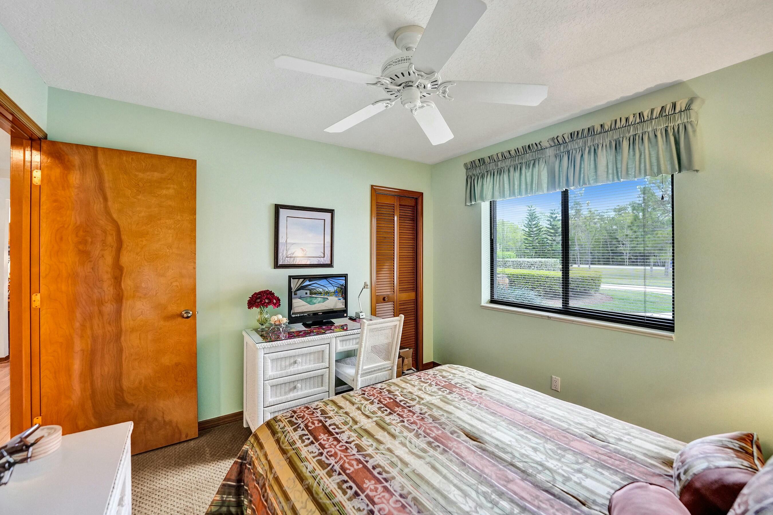 3120 Southeast Downwinds Road Jupiter, FL 33478 - Photo 21 of 33 a bedroom with a bed and a window