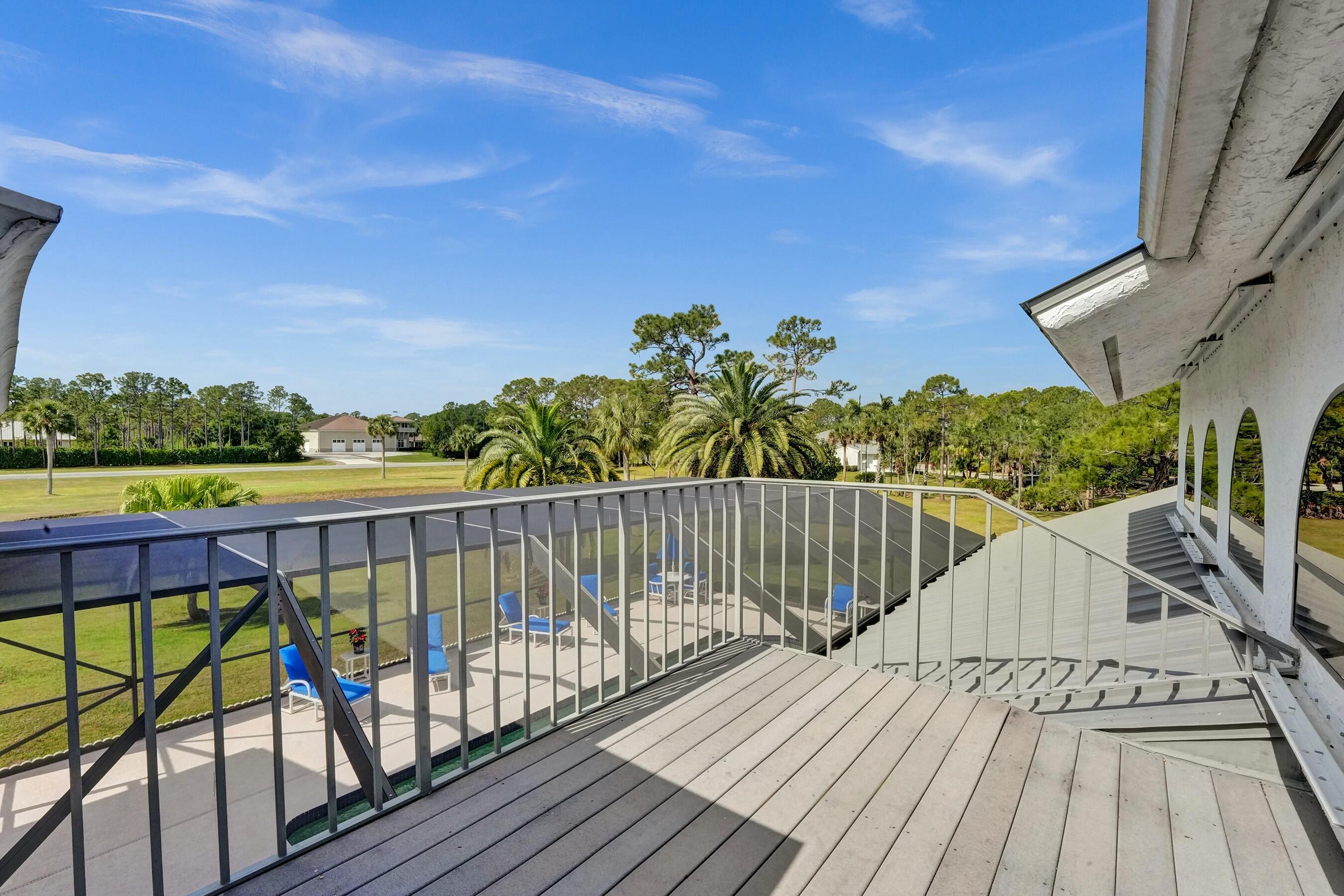 3120 Southeast Downwinds Road Jupiter, FL 33478 - Photo 25 of 33 a view of balcony with wooden floor & fence