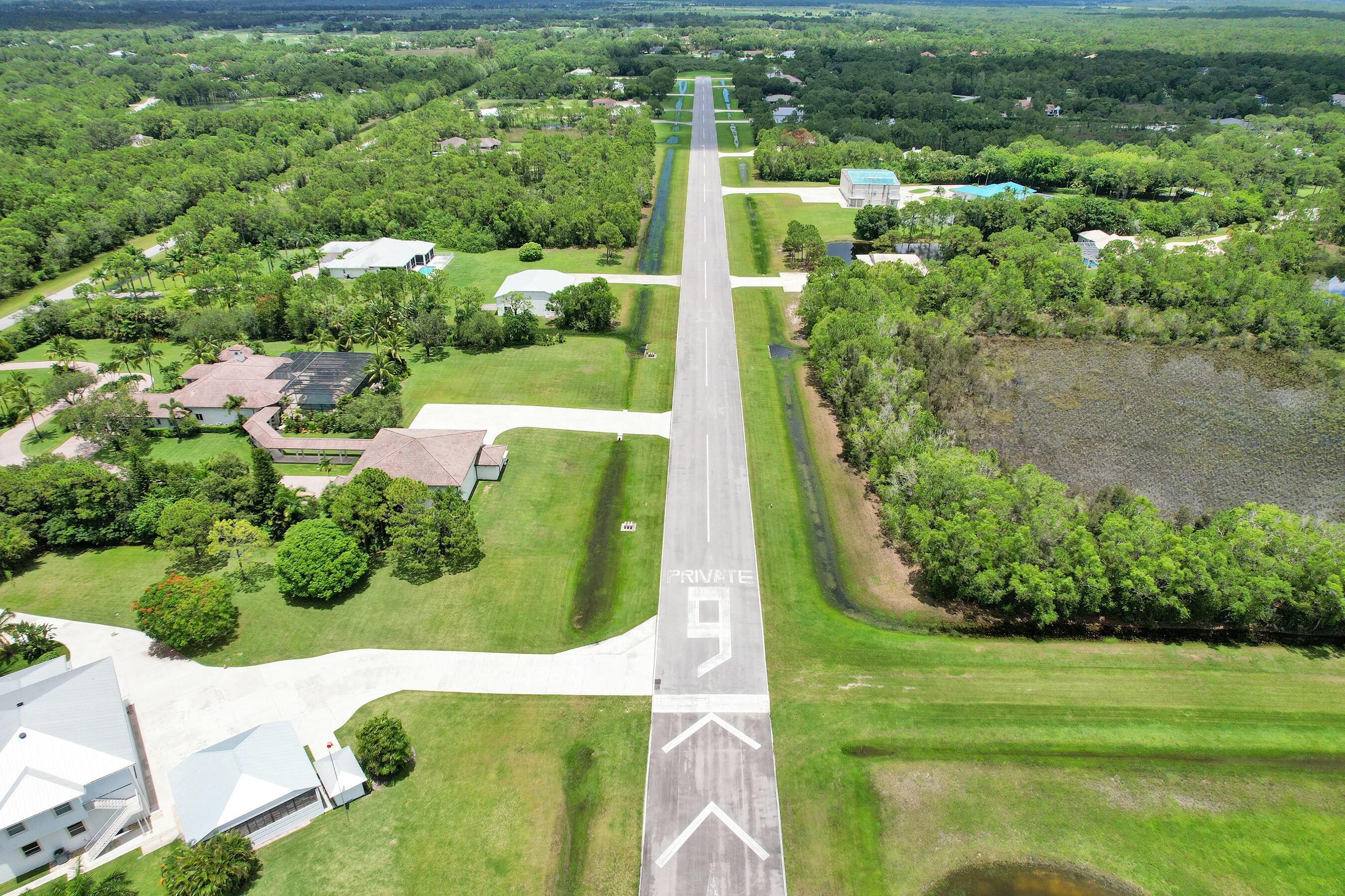 3120 Southeast Downwinds Road Jupiter, FL 33478 - Photo 30 of 33 an aerial view of a residential houses with outdoor space and trees
