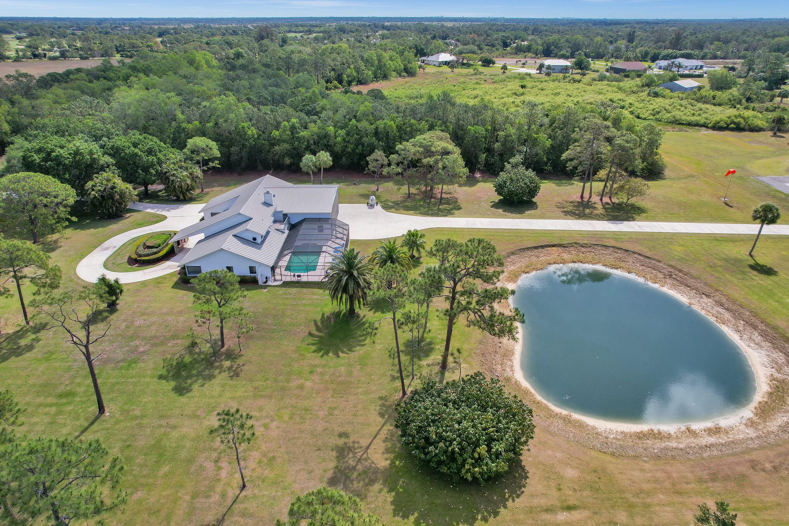 3120 Southeast Downwinds Road Jupiter, FL 33478 - Photo 3 of 33 an aerial view of a house with a yard and lake view