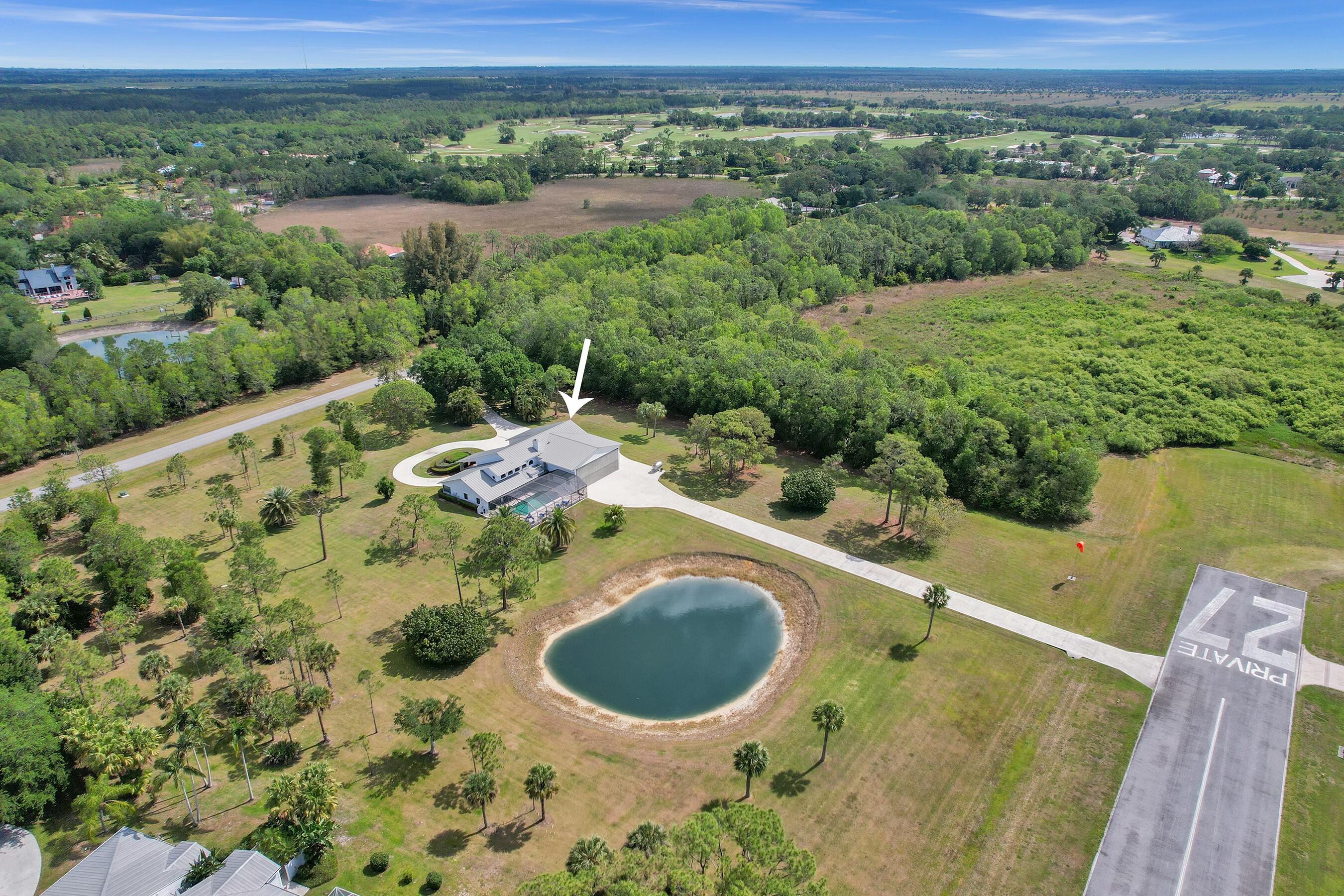 3120 Southeast Downwinds Road Jupiter, FL 33478 - Photo 4 of 33 a view of a swimming pool and mountains