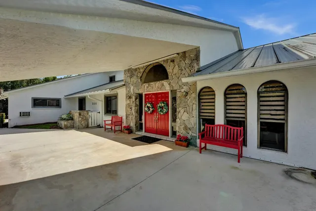 a front view of a house with barbeque and outdoor seating