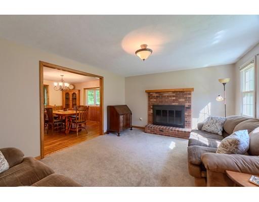 55 Norris Road Tyngsborough, MA 01879 - Photo 11 of 29 a living room with furniture and a fireplace
