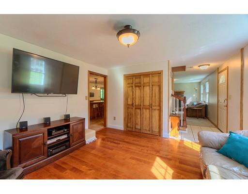 55 Norris Road Tyngsborough, MA 01879 - Photo 12 of 29 a living room with furniture and a flat screen tv